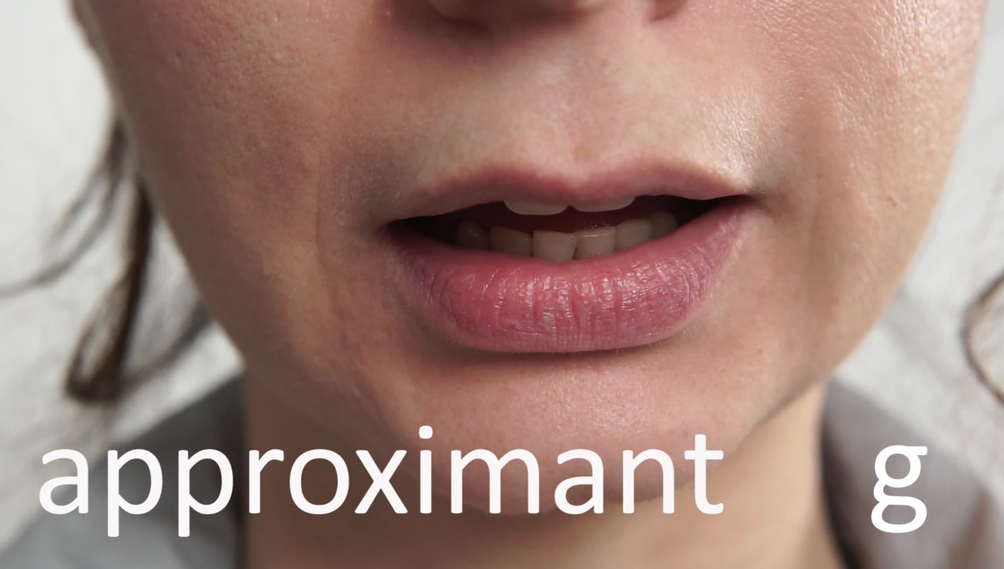 The image shows a close up of someone's open mouth with the word "approximant g" written across the bottom in white.